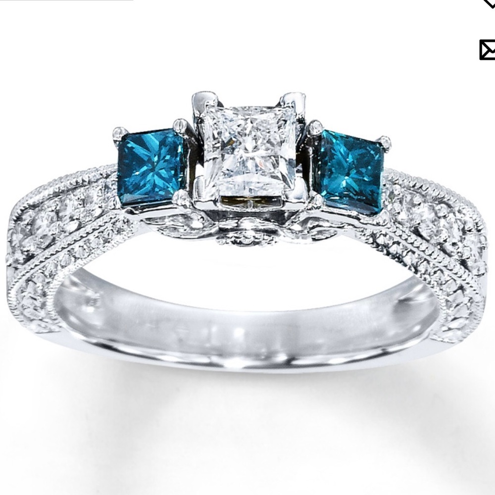 Exquisite 3 stone past present and future ring with white and blue diamonds.